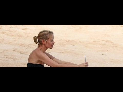 Lara Bingle takes selfies at the beach in a swimsuit
